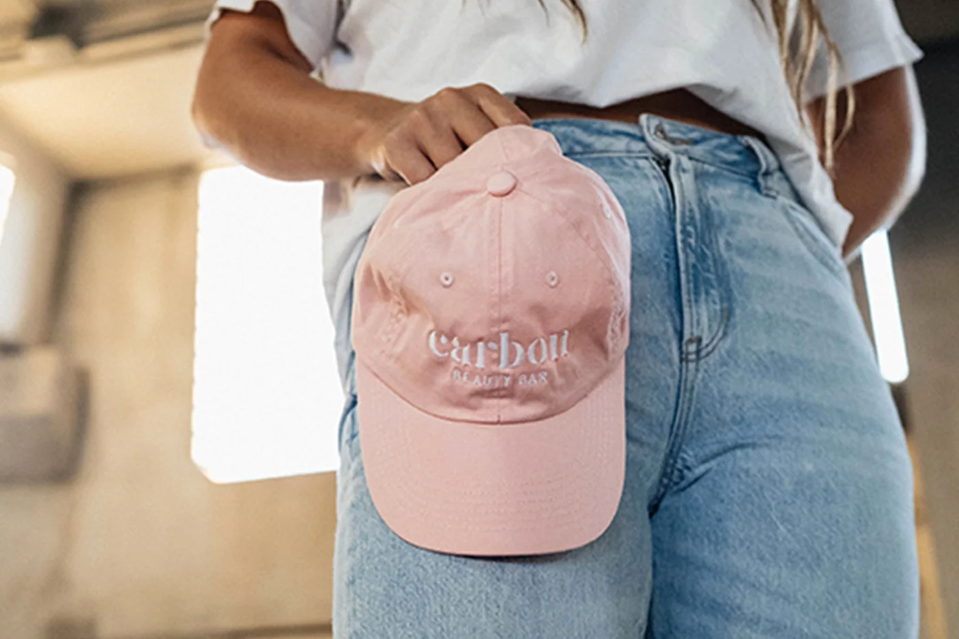 Carbon Beauty branding embroidered on a pink cap